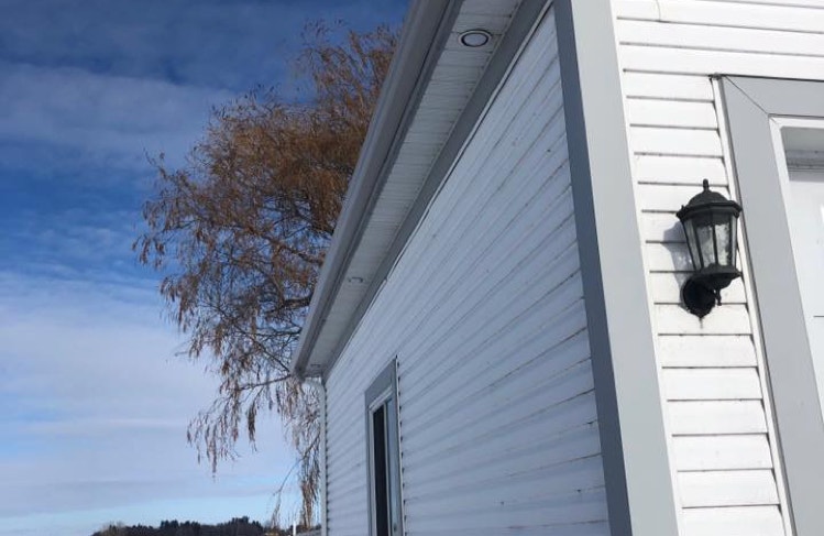 A garage with a new 2-tone aluminum cladding.